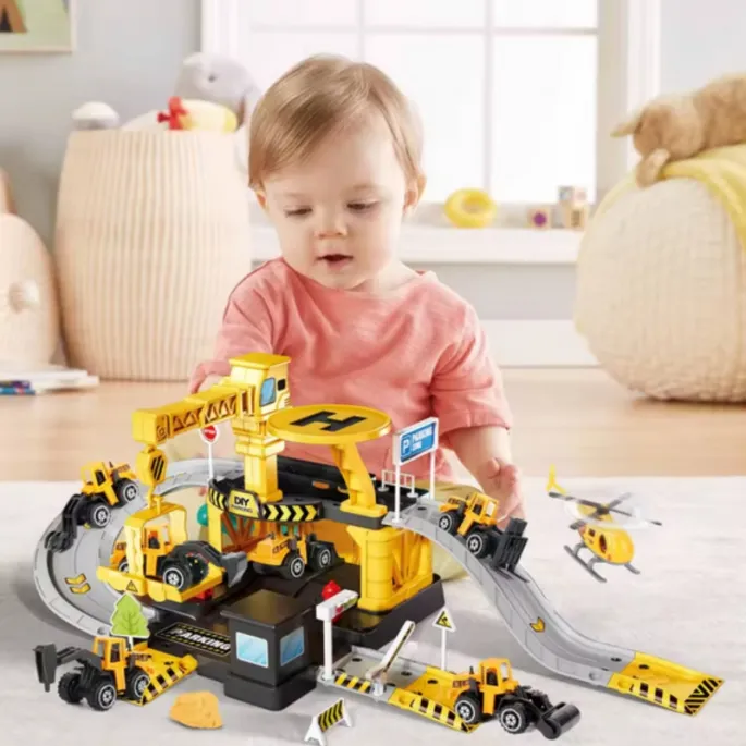 Dzieci bawiące się w garażu z robotami drogowymi.