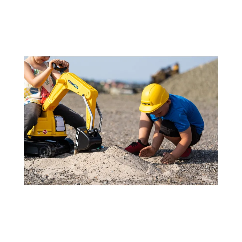 Kask ochronny w zestawie z małą koparką.