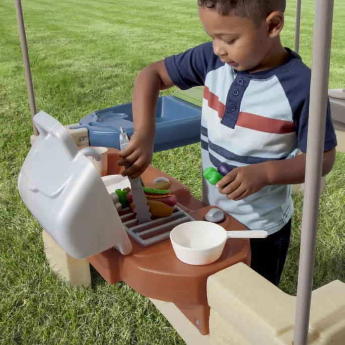 Dzieci bawiące się w kuchnię na świeżym powietrzu