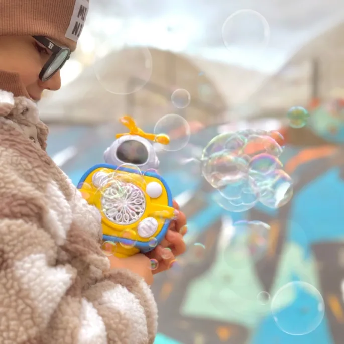 Kolorowe bańki mydlane z maszyny astronauty dla dzieci.