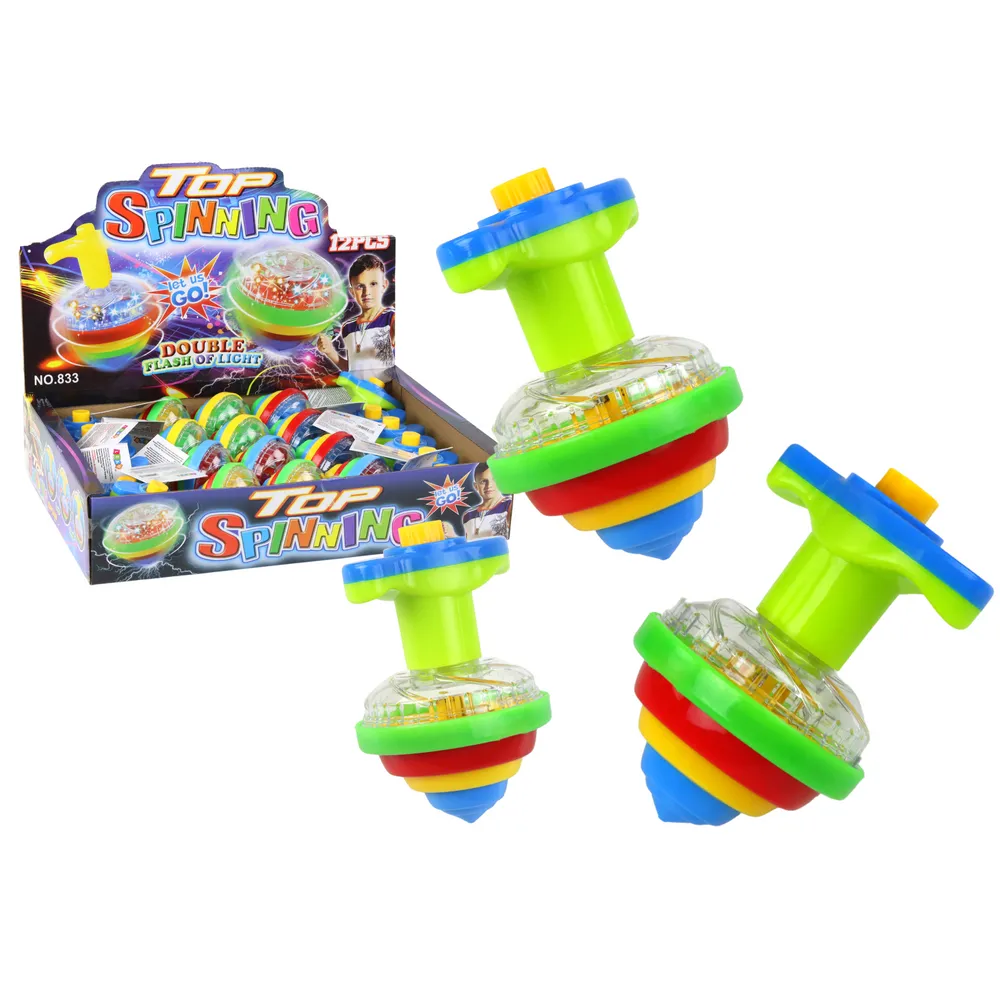 Kolorowy świecący bączek wirujący na jasnej powierzchni