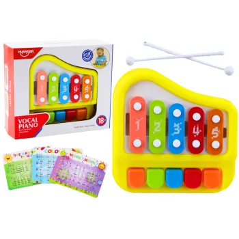 Żółte pianinko cymbałki dzwonki dla dzieci na białym tle