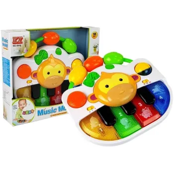 Kolorowe pianinko z małpką dla niemowlaka na białym tle