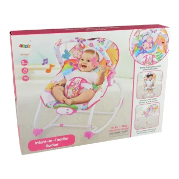 Różowa kołyska z miękkim siedziskiem i okręgiem z maskotkami