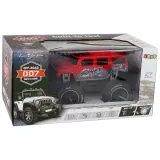 Zestaw: samochód terenowy RC 1:14, pilot i akumulator, na tle opakowania