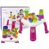 Różowy interaktywny stolik edukacyjny z sorterem kształtów i zjeżdżalnią piłeczek