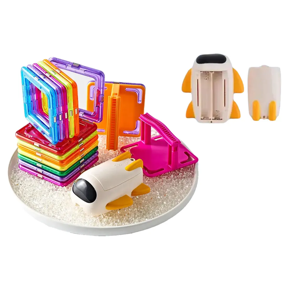 Dziecko budujące z magnetycznych klocków tor z odrzutowcem