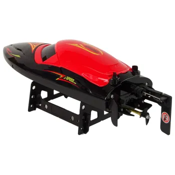 Pilot obsługi motorówki RC z podświetleniem leżący obok zabawki