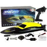 Motorówka RC żółta na wodzie z falami w tle