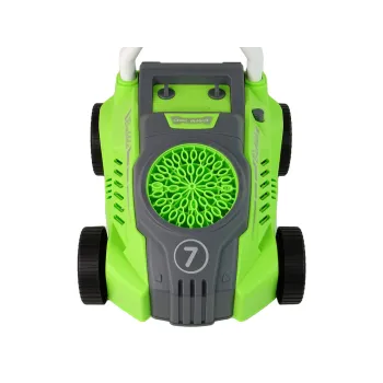 Dziecko bawiące się zieloną maszyną do baniek mydlanych