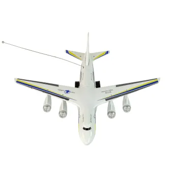 Zestaw: samolot RC, pilot oraz oryginalne opakowanie na tle stołu