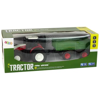 Traktor w zestawie z zieloną przyczepą i wygodnym sterownikiem