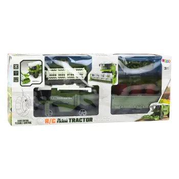 Zestaw z kombajnem RC, przyczepą i pilotem widoczny na białym tle