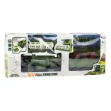 Zestaw z kombajnem RC, przyczepą i pilotem widoczny na białym tle