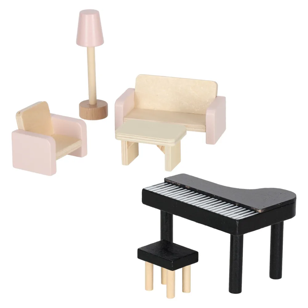 Zbliżenie na salon domku dla lalek z miniaturowymi mebelkami