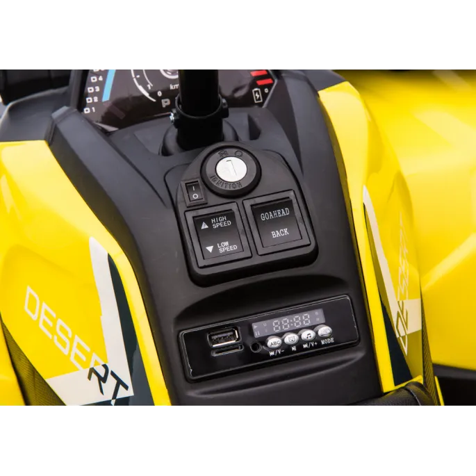 Widok z boku na żółty quad elektryczny przeznaczony dla dzieci