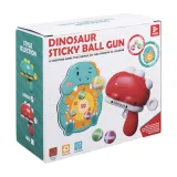 pistolet w kształcie dinozaura z kolorowymi piłeczkami na stole