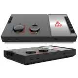 zestaw: konsola Atari, joysticki, kable i instrukcja obok siebie