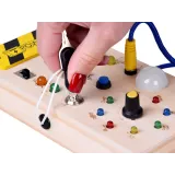 detal pokrętła i kolorowych światełek na drewnianej tablicy