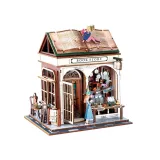 Wnętrze miniaturowej księgarni z widocznymi półkami i figurkami czytelników