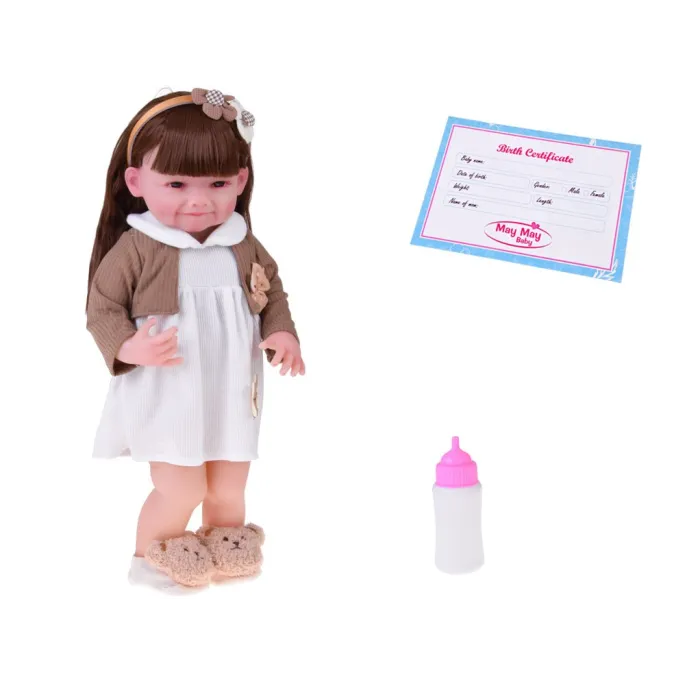 lalka w białej sukience z kwiatową aplikacją oraz brązowym sweterkiem