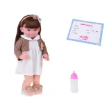 lalka w białej sukience z kwiatową aplikacją oraz brązowym sweterkiem