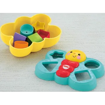 Motylek Fisher-Price wraz z różnokolorowymi klockami na stole