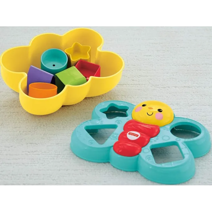 Motylek Fisher-Price wraz z różnokolorowymi klockami na stole