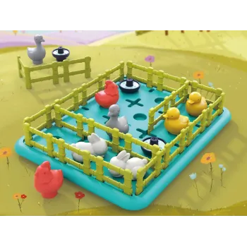 Dziecko układa zwierzątka i płoty na planszy gry Wesoła farma