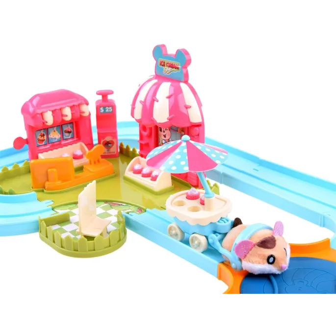 miękki chomik na torze wśród miniaturowych deserów lodowych