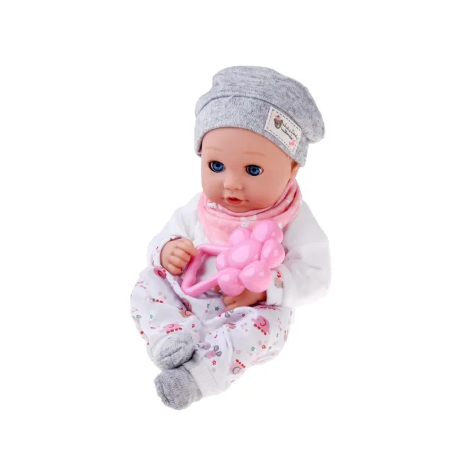 Lalka bobas w miękkiej bluzeczce leżąca na boku