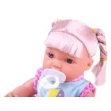 Lalka w pozycji leżącej z widocznym nosidełkiem i akcesoriami