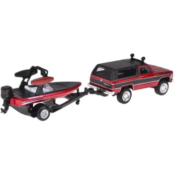 Odczepiana łódź umieszczona na przyczepie obok samochodu terenowego