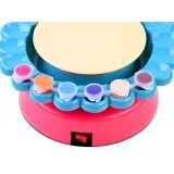 Widok maszyny do ceramiki wraz z zestawem farb i narzędzi