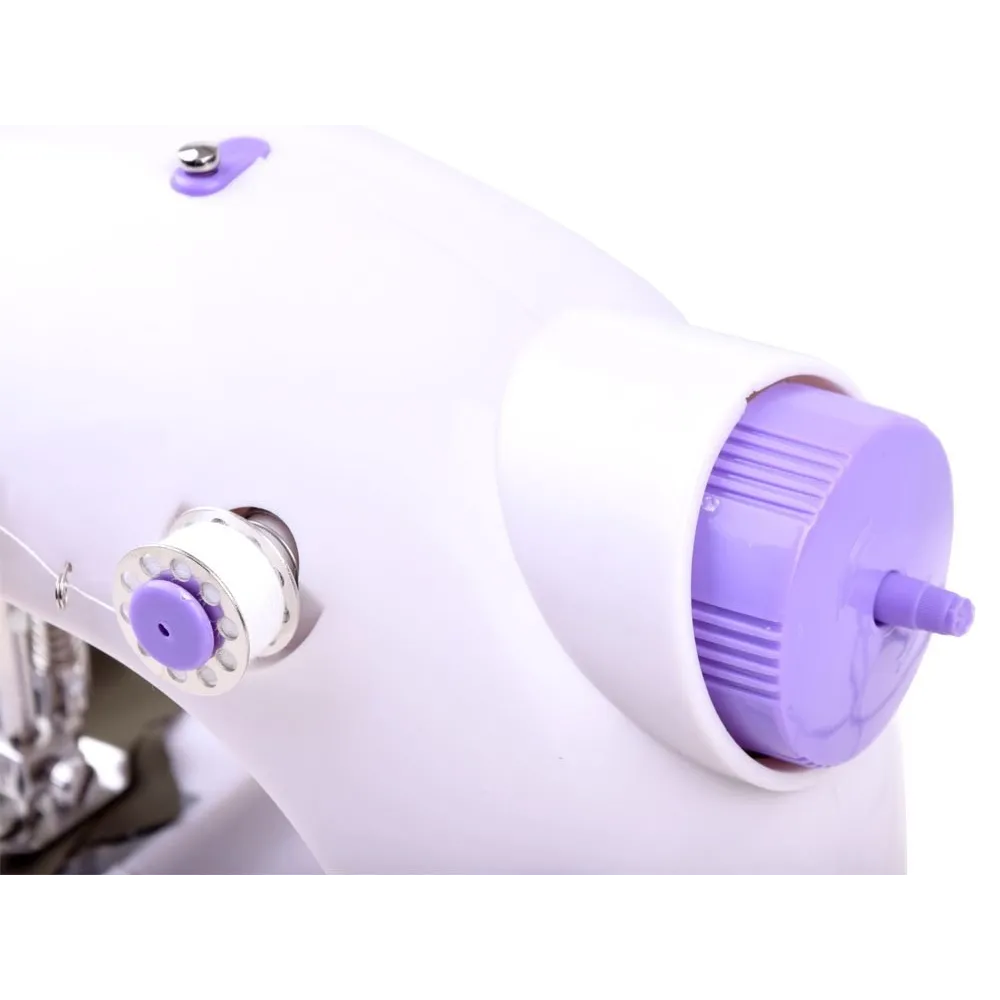 zawartość zestawu z igłą, szpulkami i nawlekaczem przy maszynie do szycia