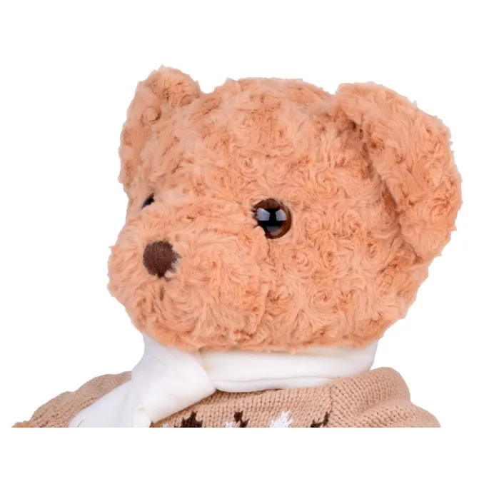 miś maskotka uchwycony w pozycji siedzącej na łóżku