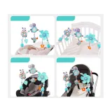 pałąk z zawieszkami w łóżeczku dziecięcym w jasnych barwach