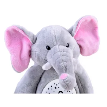 ułożony na łóżku pluszowy słonik jako lampka nocna