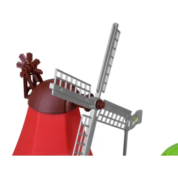 figurka gospodyni przy zagrodzie dla zwierząt, obok zielonej podstawy