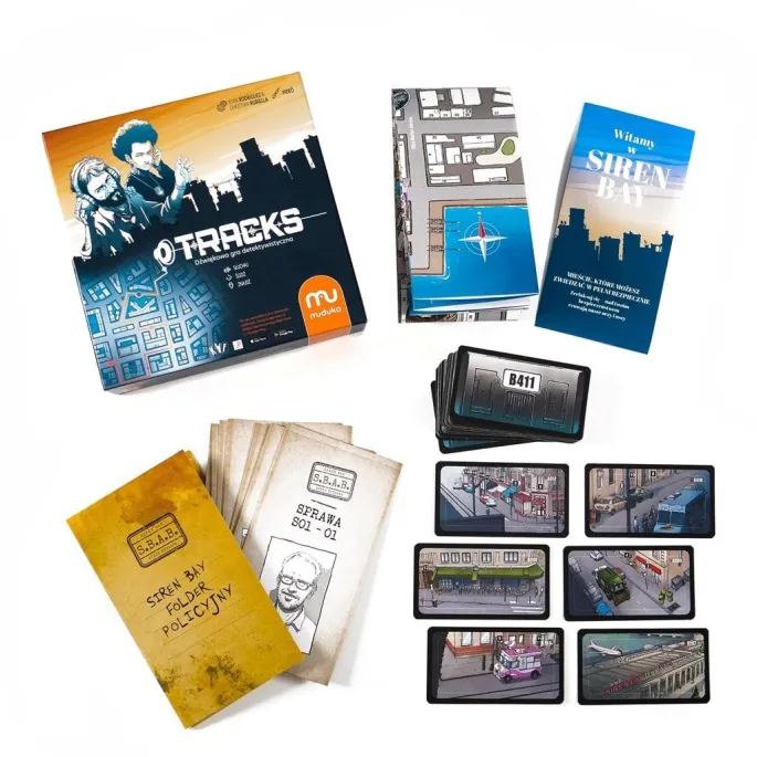 pudełko gry Tracks MUDUKO z elementami zestawu widocznymi na pierwszym planie