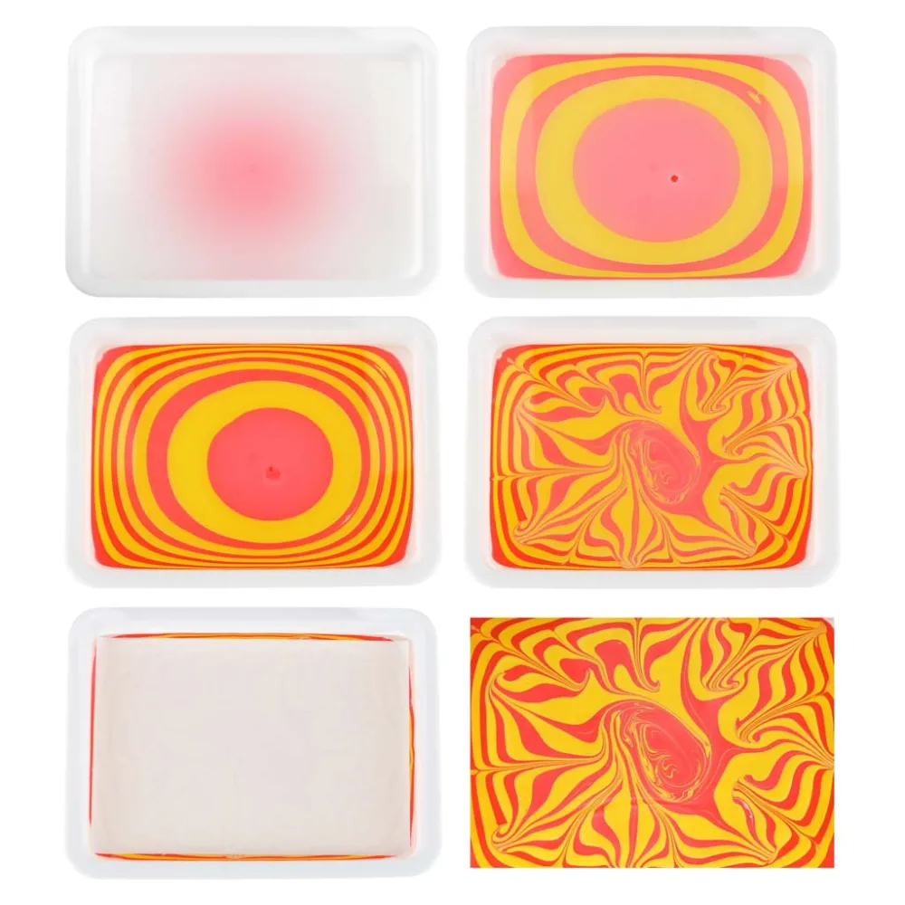 narzędzia do ebru: pipety, szpilki, pęseta na tle butelki z koncentratem