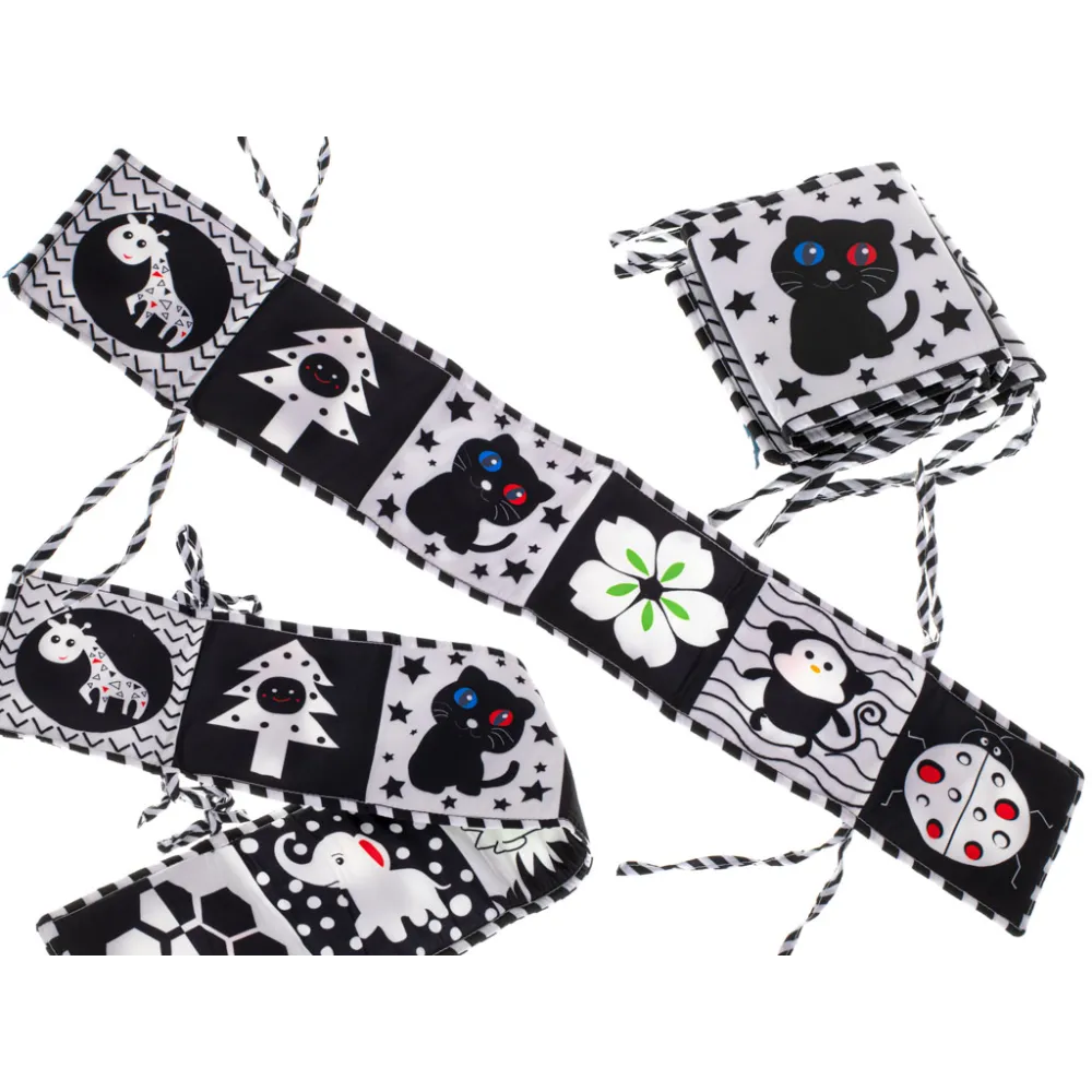 Sensoryczna książeczka kontrastowa przypięta do łóżeczka dziecięcego